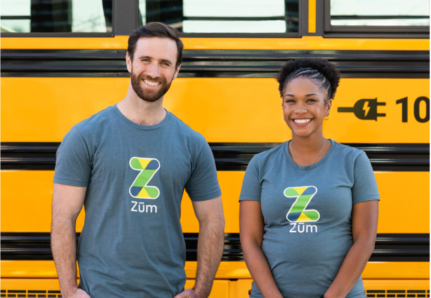 Zum drivers standing in front of bus